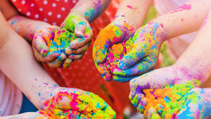 Childrens at a daycare and holding colour powders