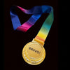 Gold medal with 'BRAVO!' text and a rainbow ribbon on a dark background