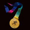 Gold medal with a colorful ribbon on a dark surface