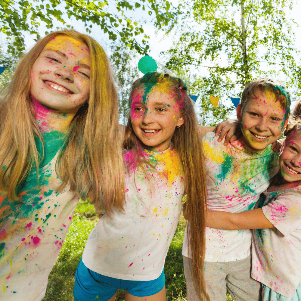 Kids wearing white t-shirt with colour powders on it