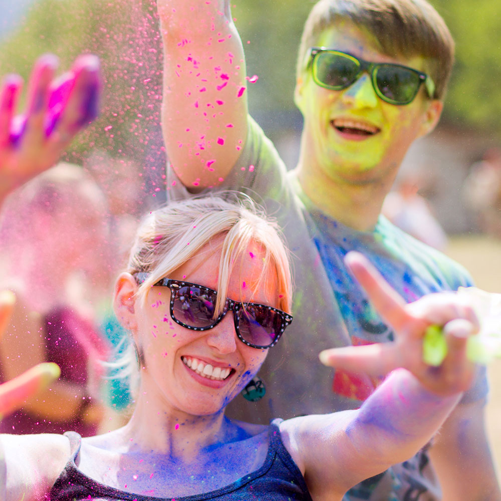 2 persons with colored sunglasses at a colour run in canada